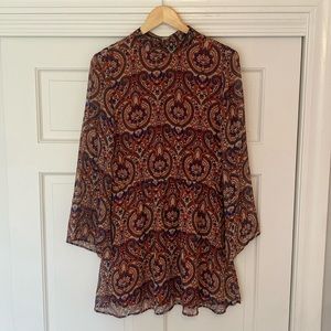 Bell sleeve pattern dress with bow-neck tie and open back